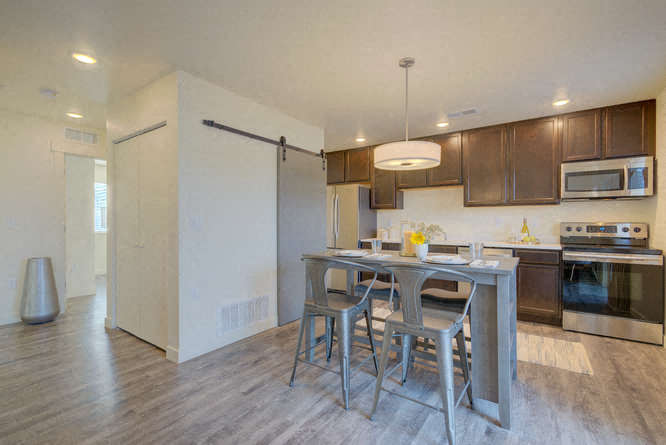 a kitchen with a breakfast bar and stainless steel appliances