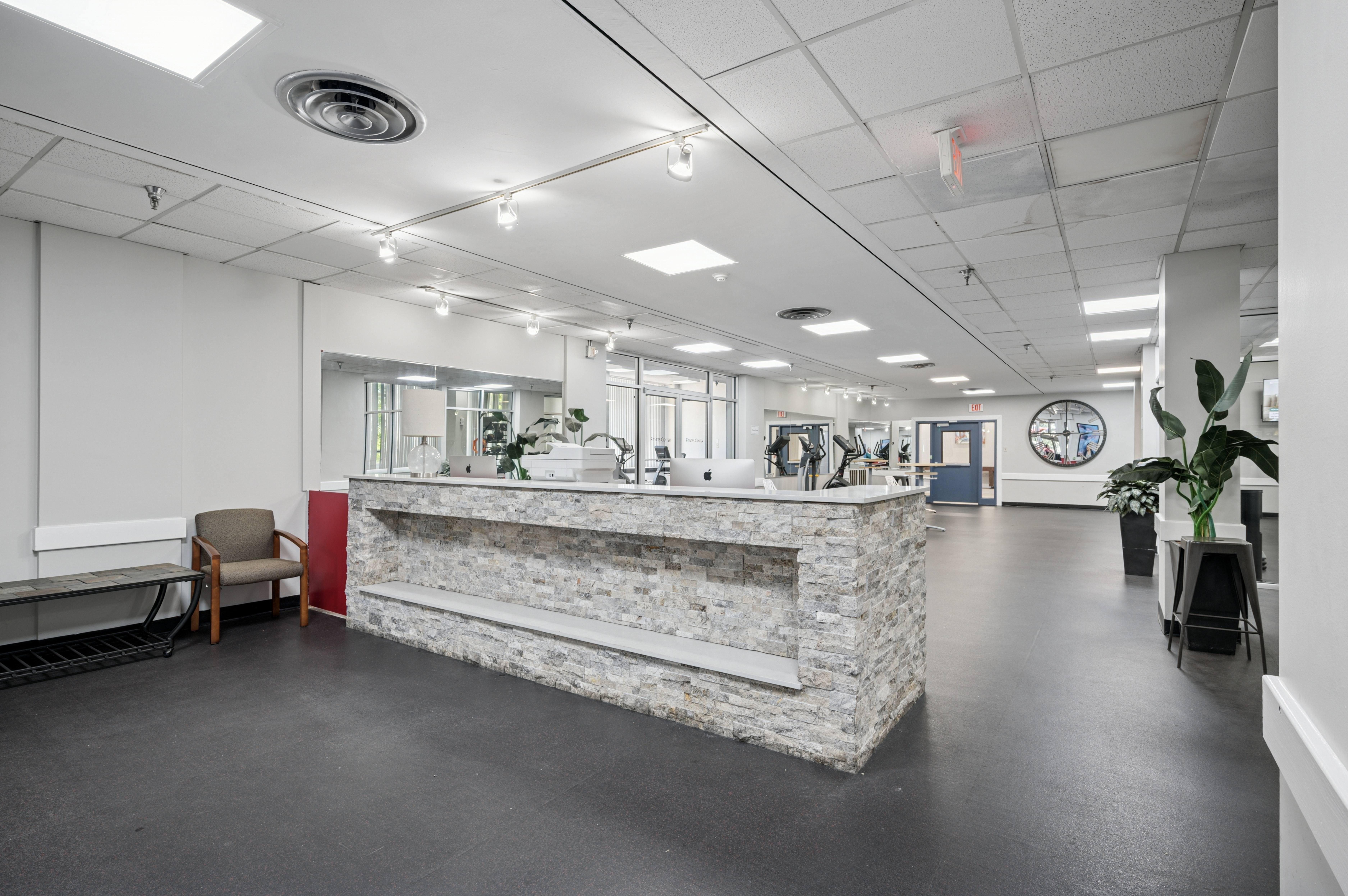 A reception area with a stone counter and a plant.