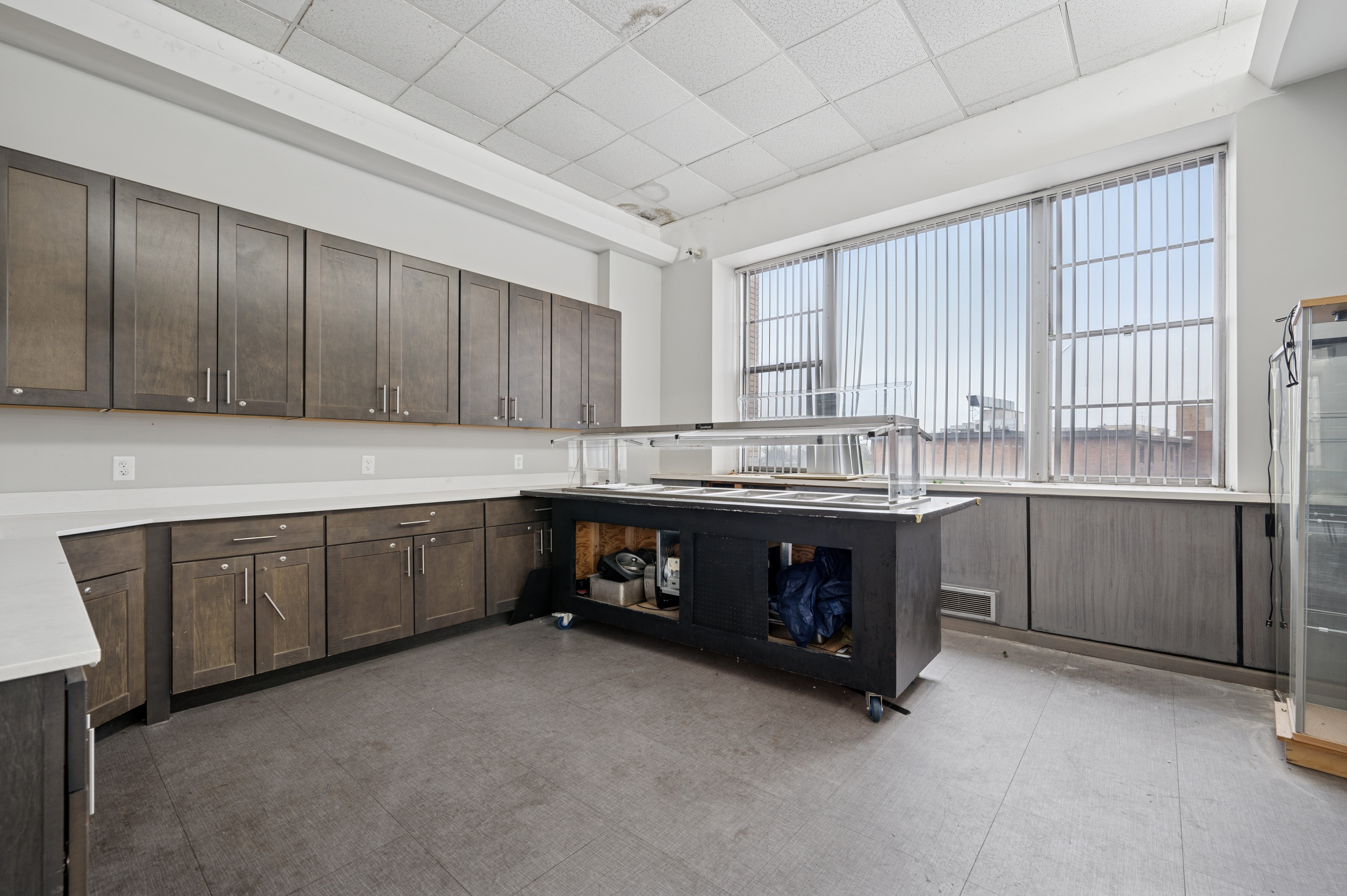 A kitchen with brown cabinets and a white countertop.