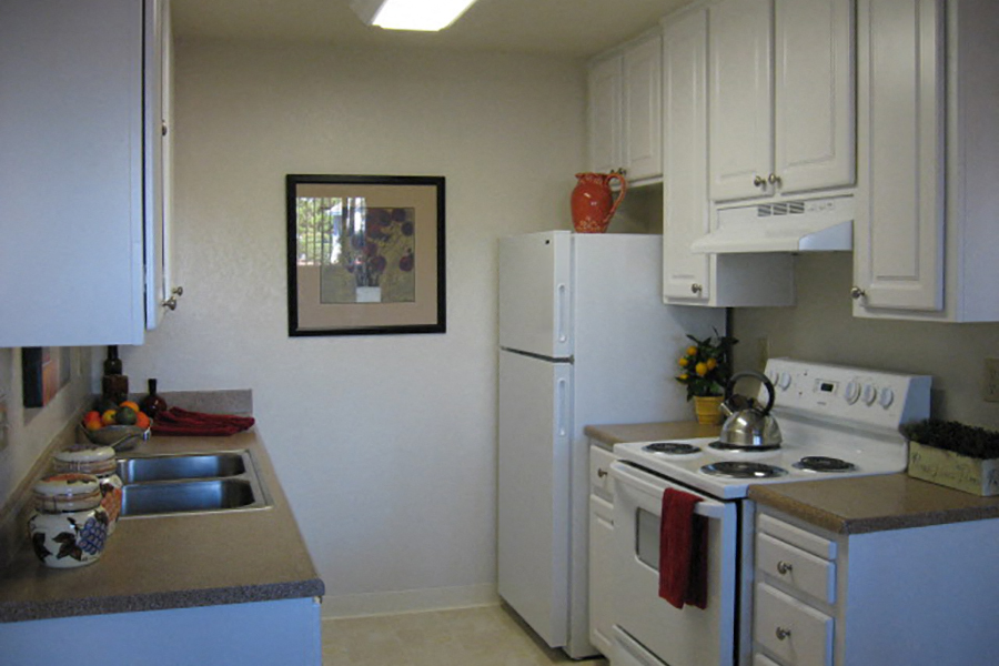 A kitchen with white appliances at the Riverstone Apartments in Antioch, California.