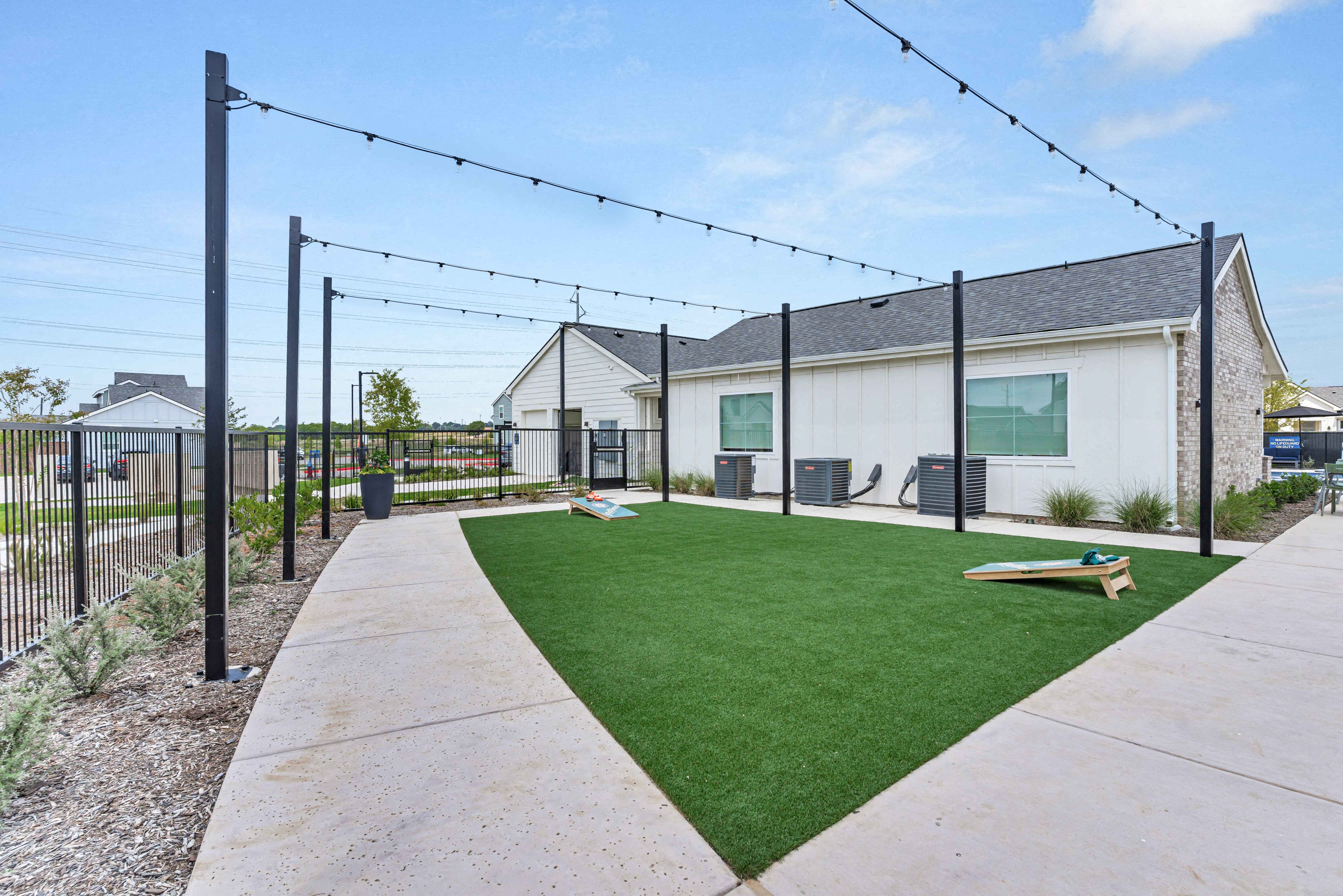 a yard with a ping pong table in front of a house