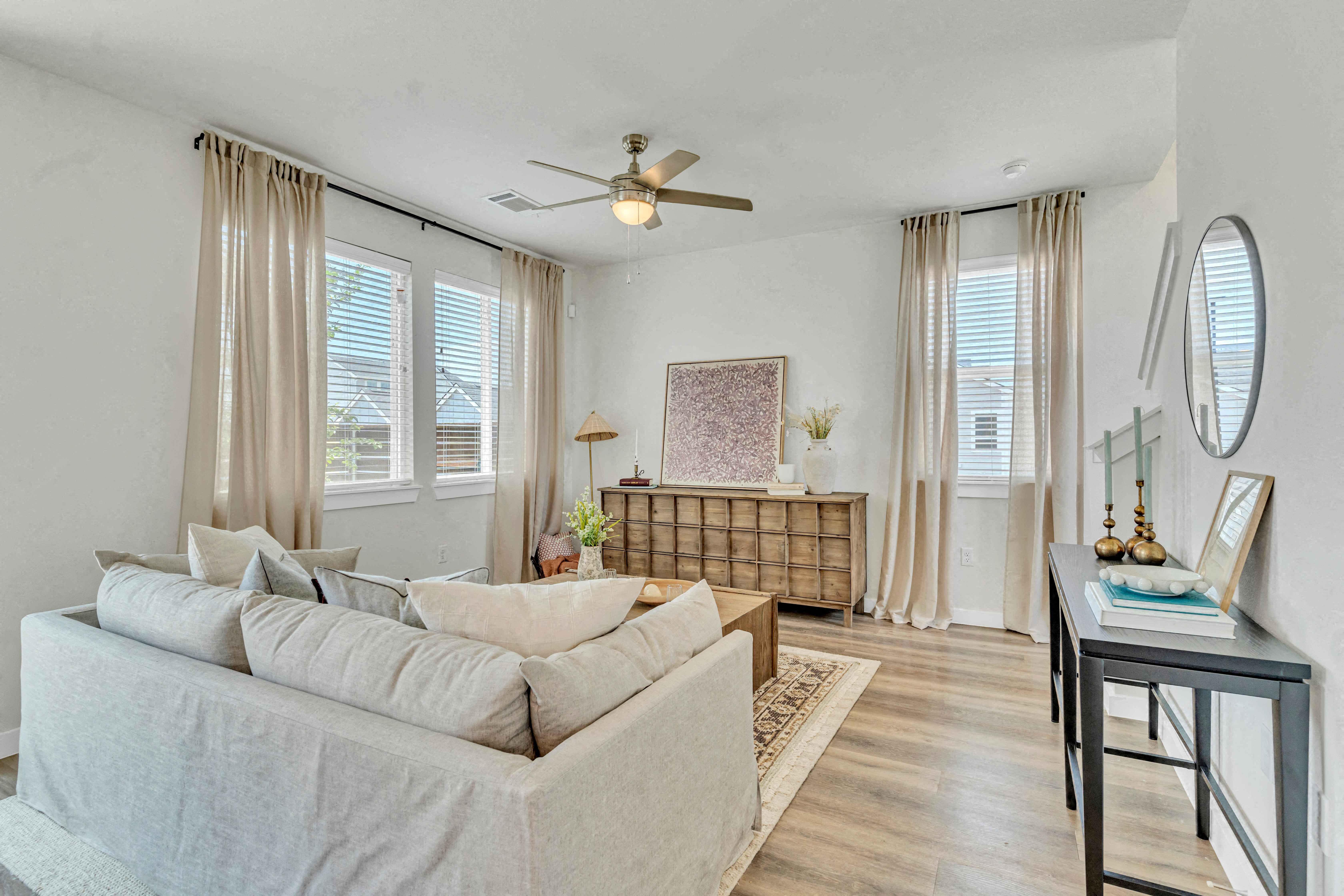 a living room with a couch and a ceiling fan