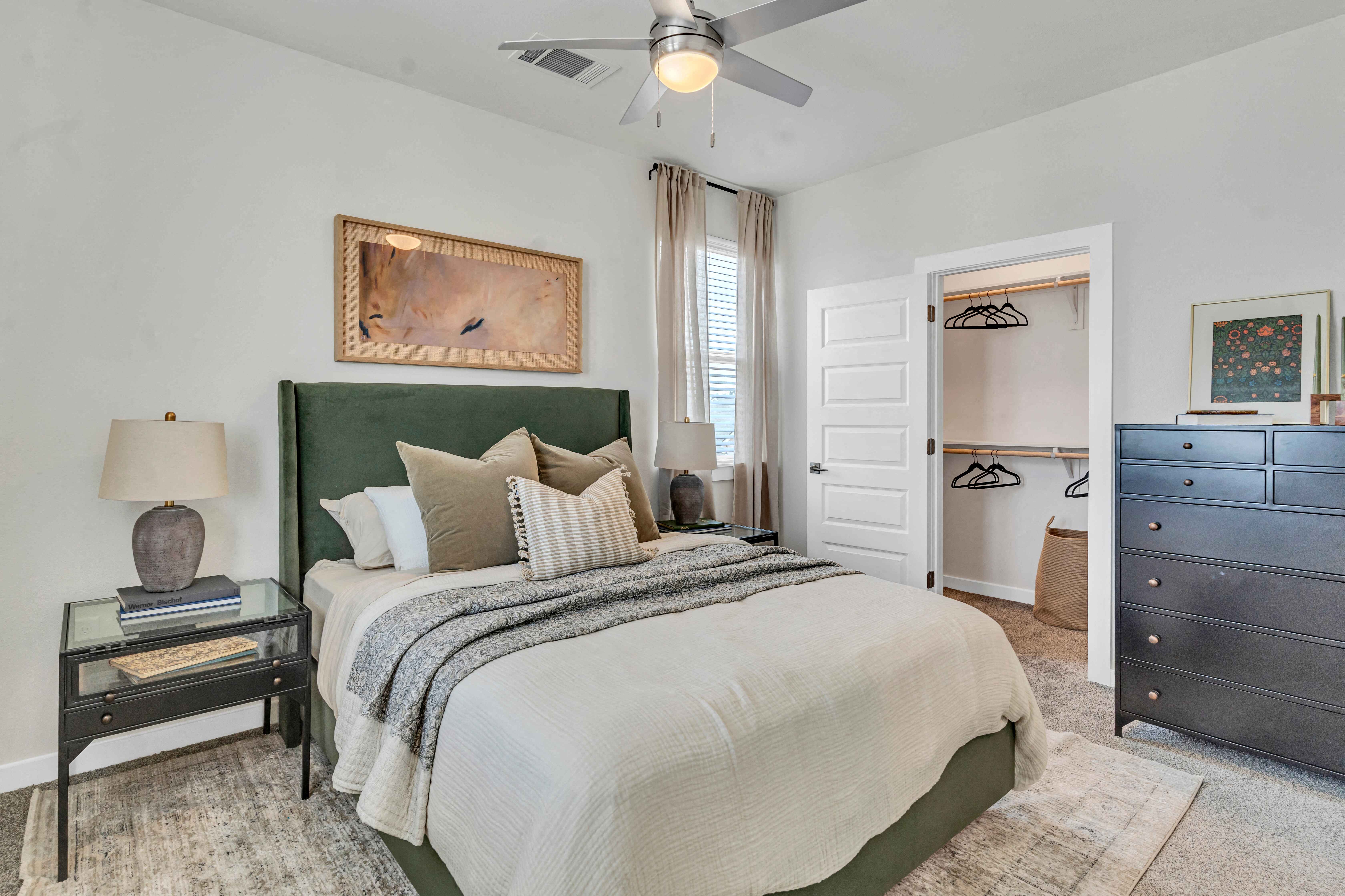 a bedroom with a bed and a ceiling fan