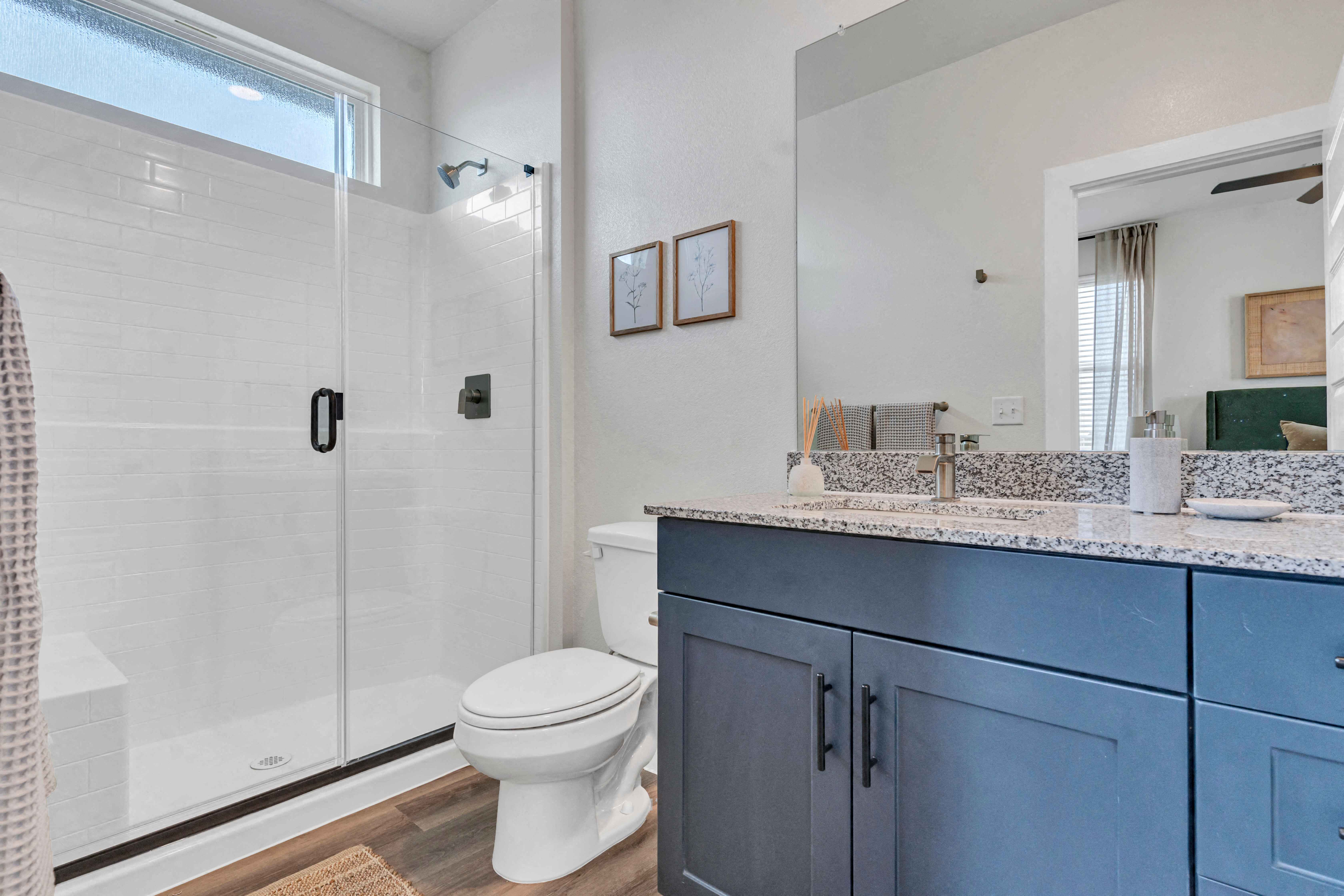 a bathroom with a shower and a toilet and a sink