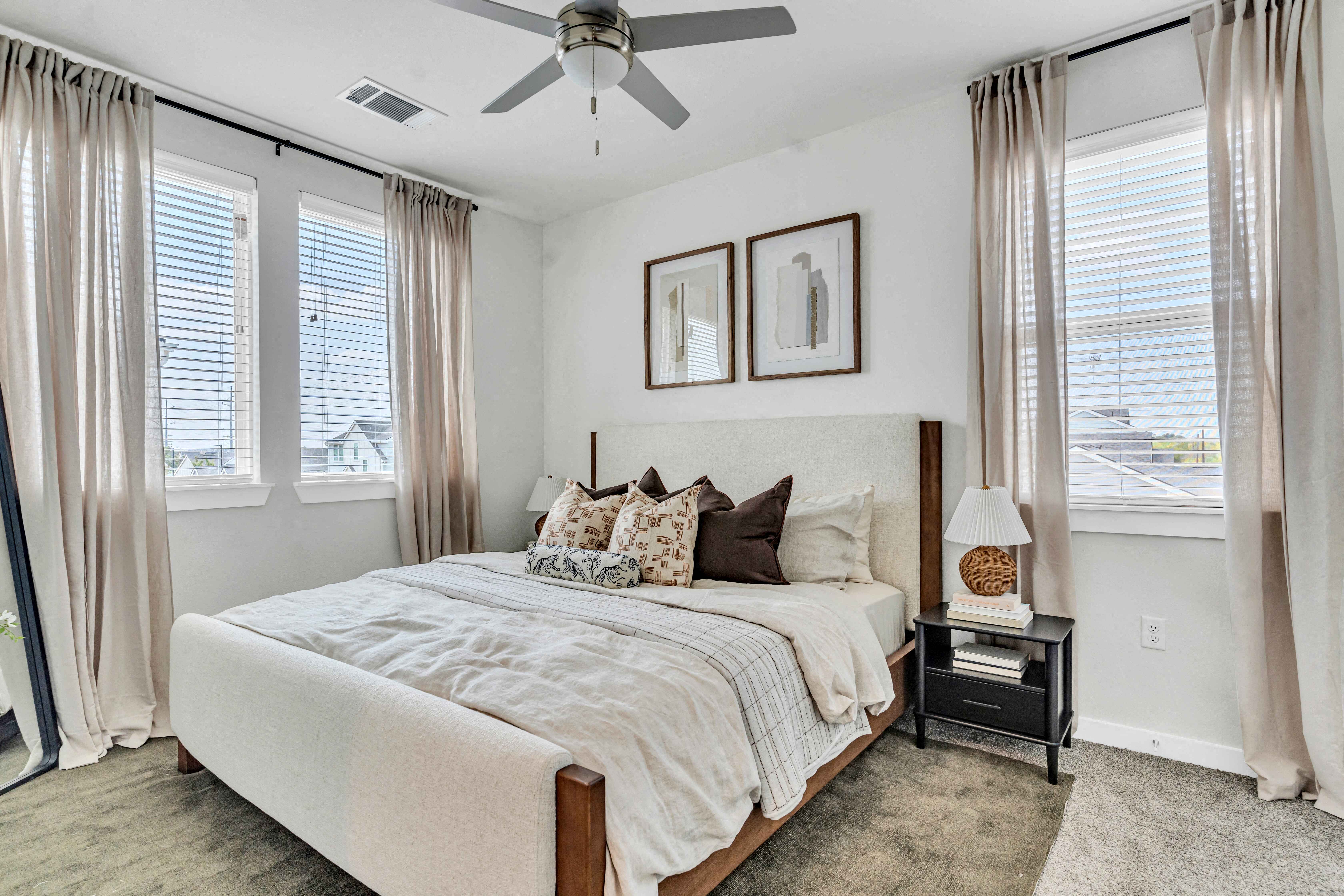 a bedroom with a bed and a ceiling fan