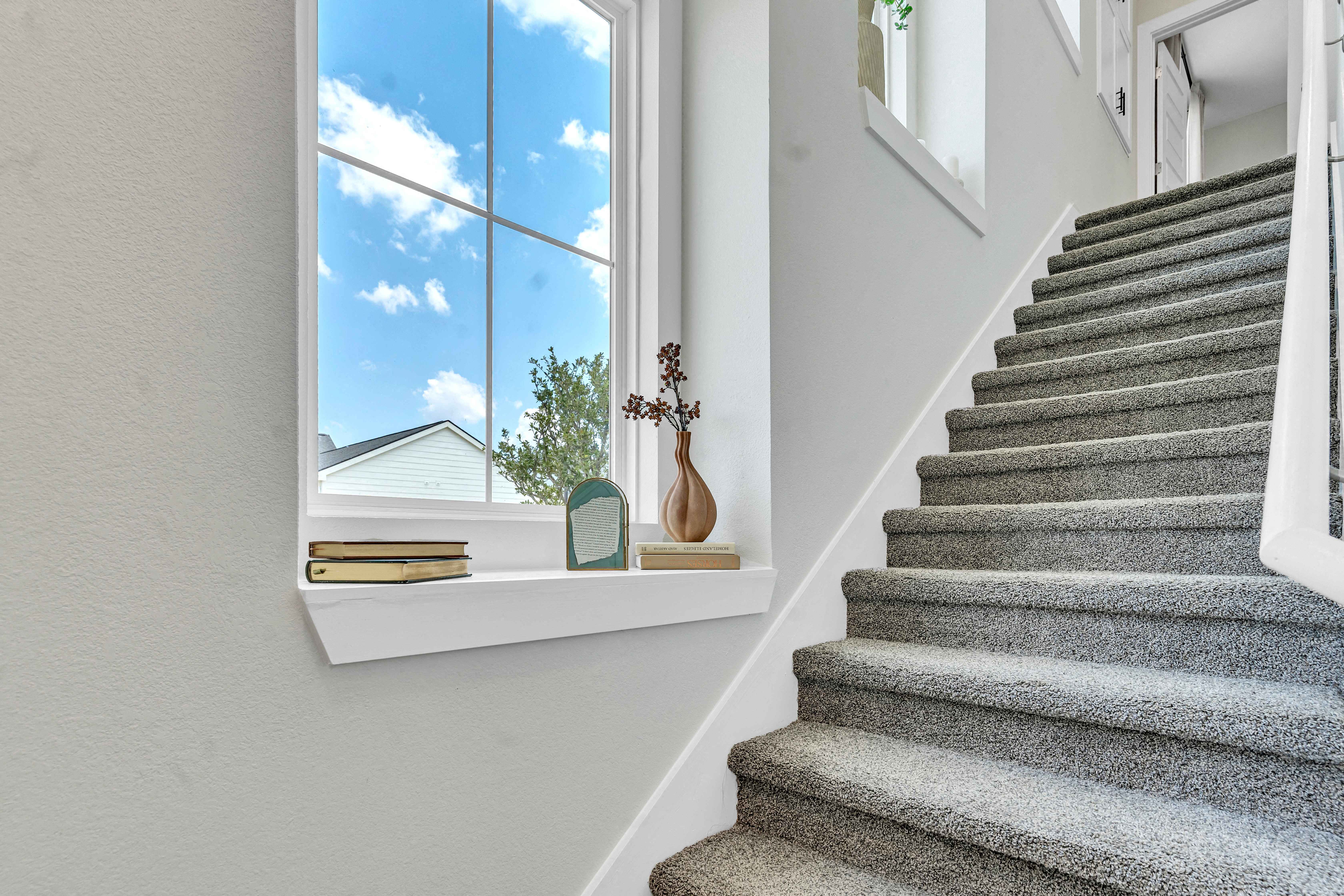 a view of a staircase and a window in a house