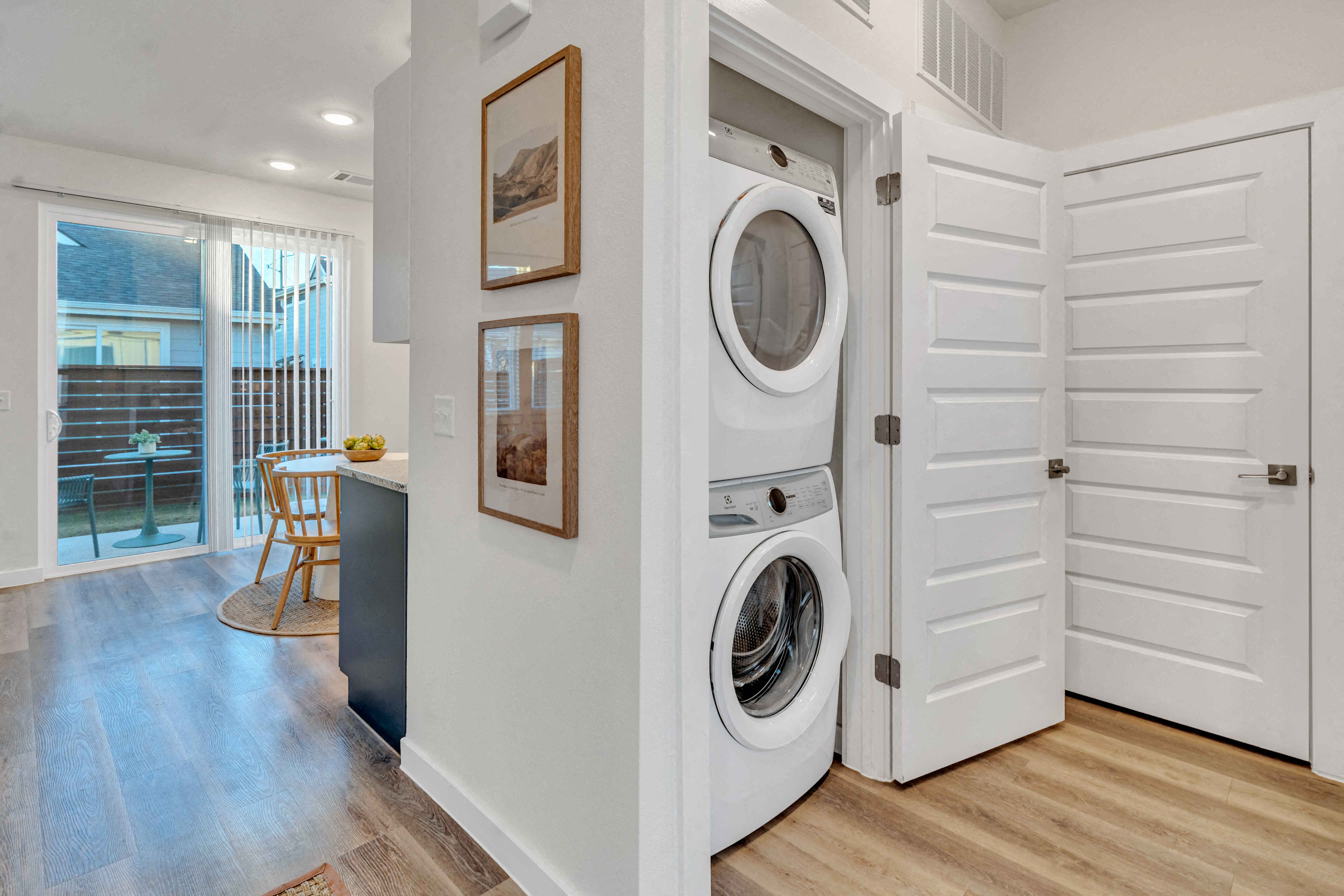 A laundry room with a washer and dryer built into the wall.