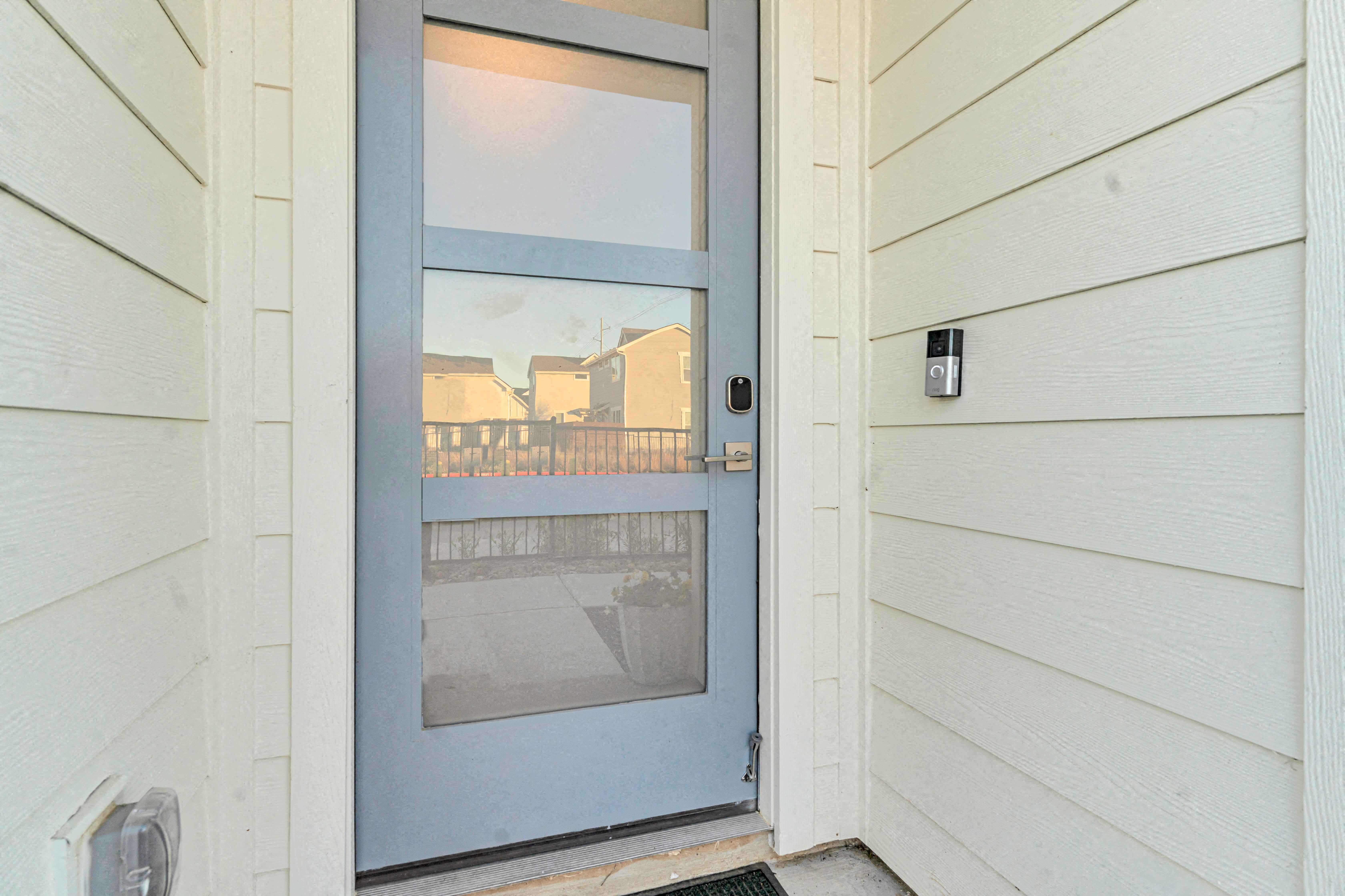 A blue door is on the left side of a white wall.