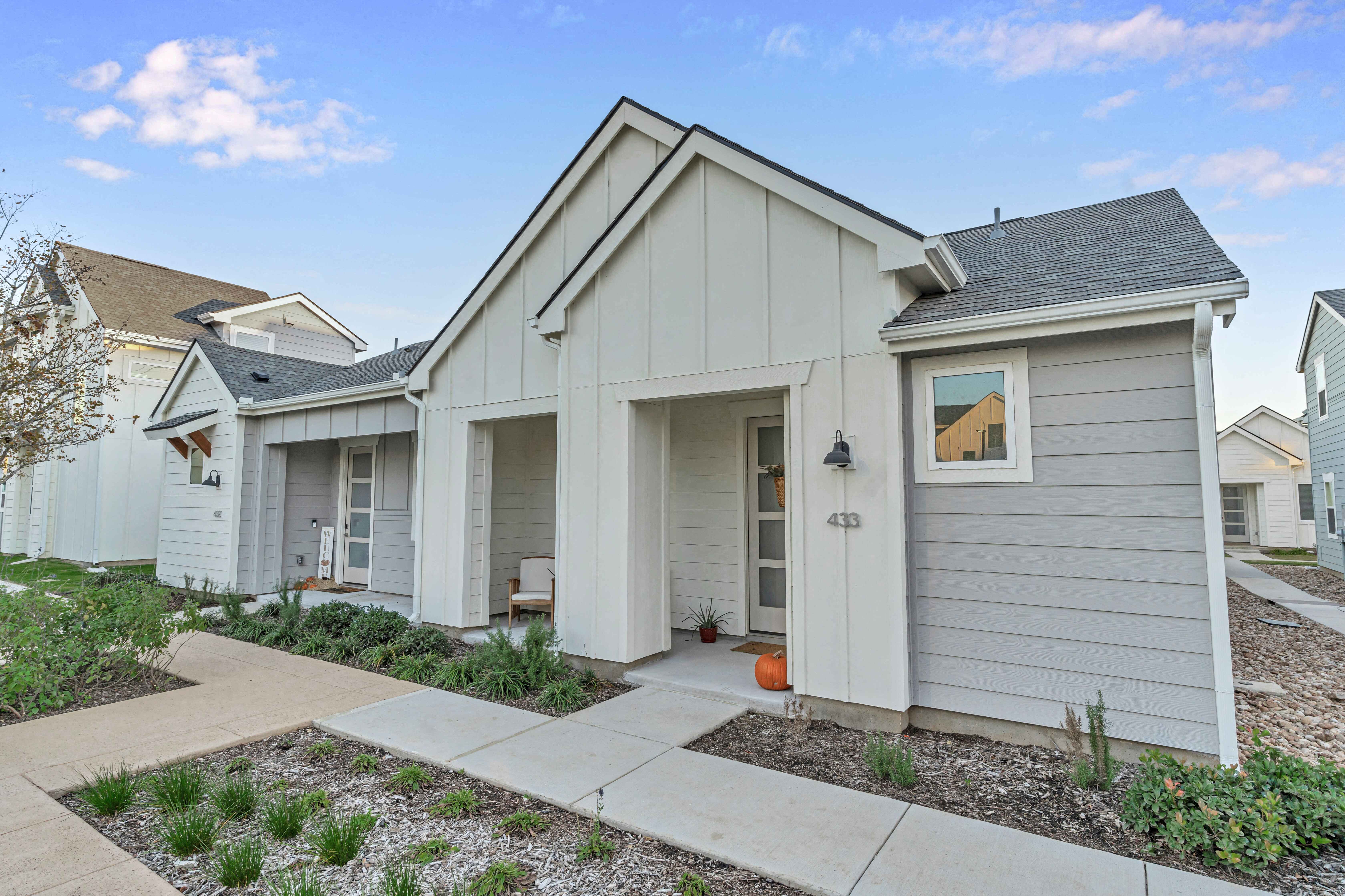 A house numbered 403 is shown with a grey siding and a white door.