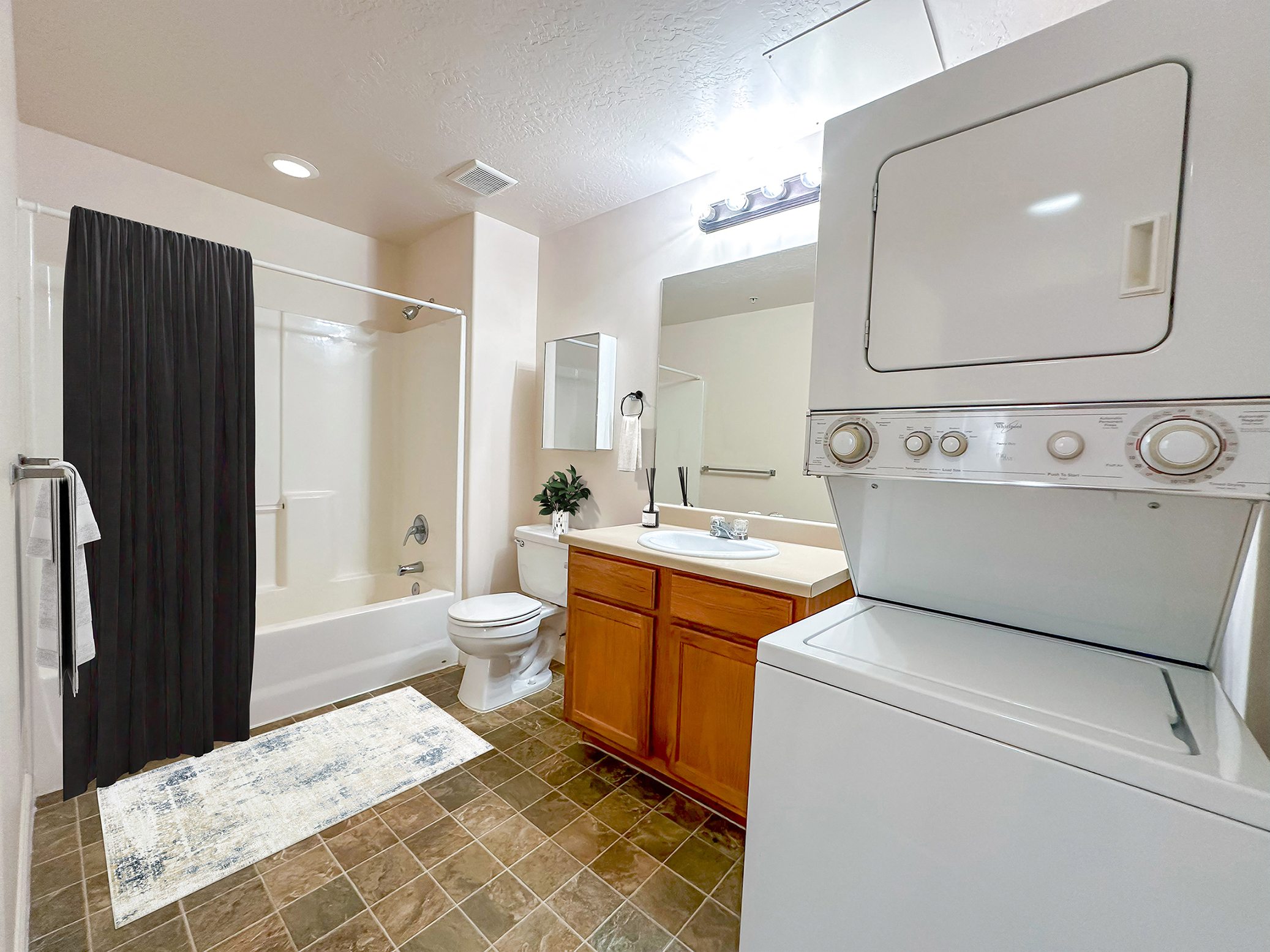 Liberty Midtown 1 Bedroom Apartment, Bathroom, Stacking Washer and Dryer, Shower and tub.