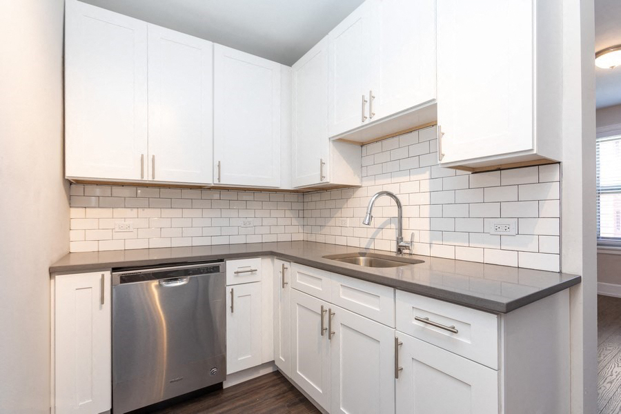 white kitchen with stainless steel appliances in hyde park chicago apartment