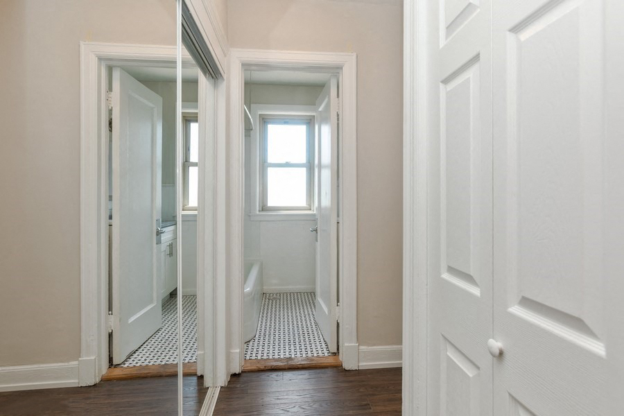 hardwood floor and large closets in living room of hyde park apartment in chicago