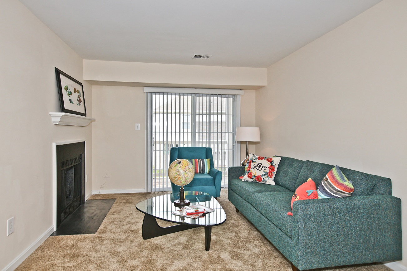 Living Room with Fireplace in the Asten Apartment at Saratoga Square